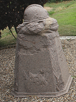 Demarcation Stone at Villers-Bretonneux, east of Amiens in France. This stone has a French helmet on the top.