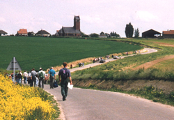 Guided walking tour on the Somme battlefield, walking towards Thiepval church.