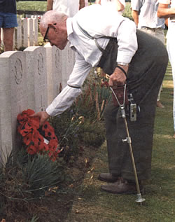 WW1 veteran Tom Price lays a poppy wreath at the grave of a comrade killed in July 1916.