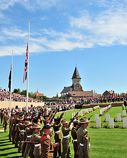 The Firing Party fire three volleys during the 19 July dedication ceremony at the new cemetery Pheasant Wood, Fromelles. 
					Photo: CWGC