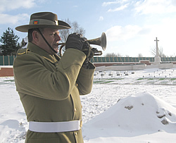 Jeff Poole, Australian Army Musician, plays the Last Post during the ceremony in February 2010 to mark the start of the reburials at Pheasant Wood cemetery.