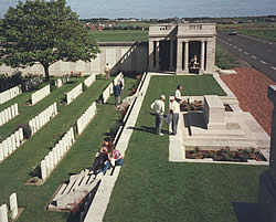 View of visitors at the War Stone and entrance to Dud Corner Cemetery on the Lens-B&eacute;thune road.