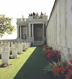 Visitors stand on the viewing platform looking across at the Loos battlefield.