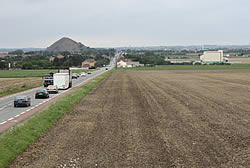 Looking north-west from the viewing platform towards the former 25 September 1915 British Front Line with the Mazingarbe slag heap in the distance.