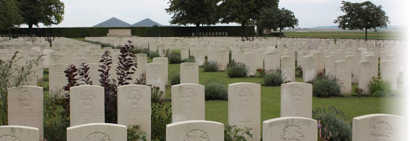 St. Mary's A.D.S. Cemetery, Haisnes, France. Looking to the south towards the War Stone, with the Double Crassier slag heaps in the distance. St. Mary's A.D.S. Cemetery, Haisnes, France.
