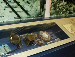 A display case containing items related to the fighting and the men of the Canadian Corps.