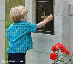 A young visitor reaches for the Visitors' Book.