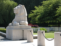 Graves of the Berks Cemetery Extension with the Ploegsteert Memorial to the Missing lion in the 
			foreground.