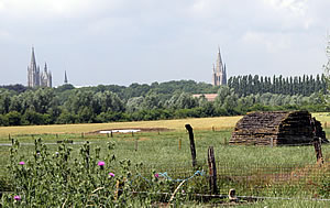 View of the spires and towers of Ypres from Transport Farm.  Note the British bunker in the foreground.