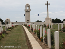 Villers-Bretonneux Memorial with graves in the Villers-Bretonneux Cemetery in the foreground.