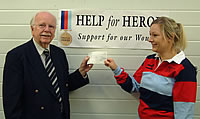 Lt Col Graham Parker hands a cheque to Help for Heroes.