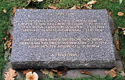 Stone grave marker at Langemark cemetery for 8 German soldiers, three of whom are unidentified.