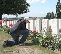 Visiting a military grave at Tyne Cot Cemetery on the Ypres Salient battlefields in Belgium.